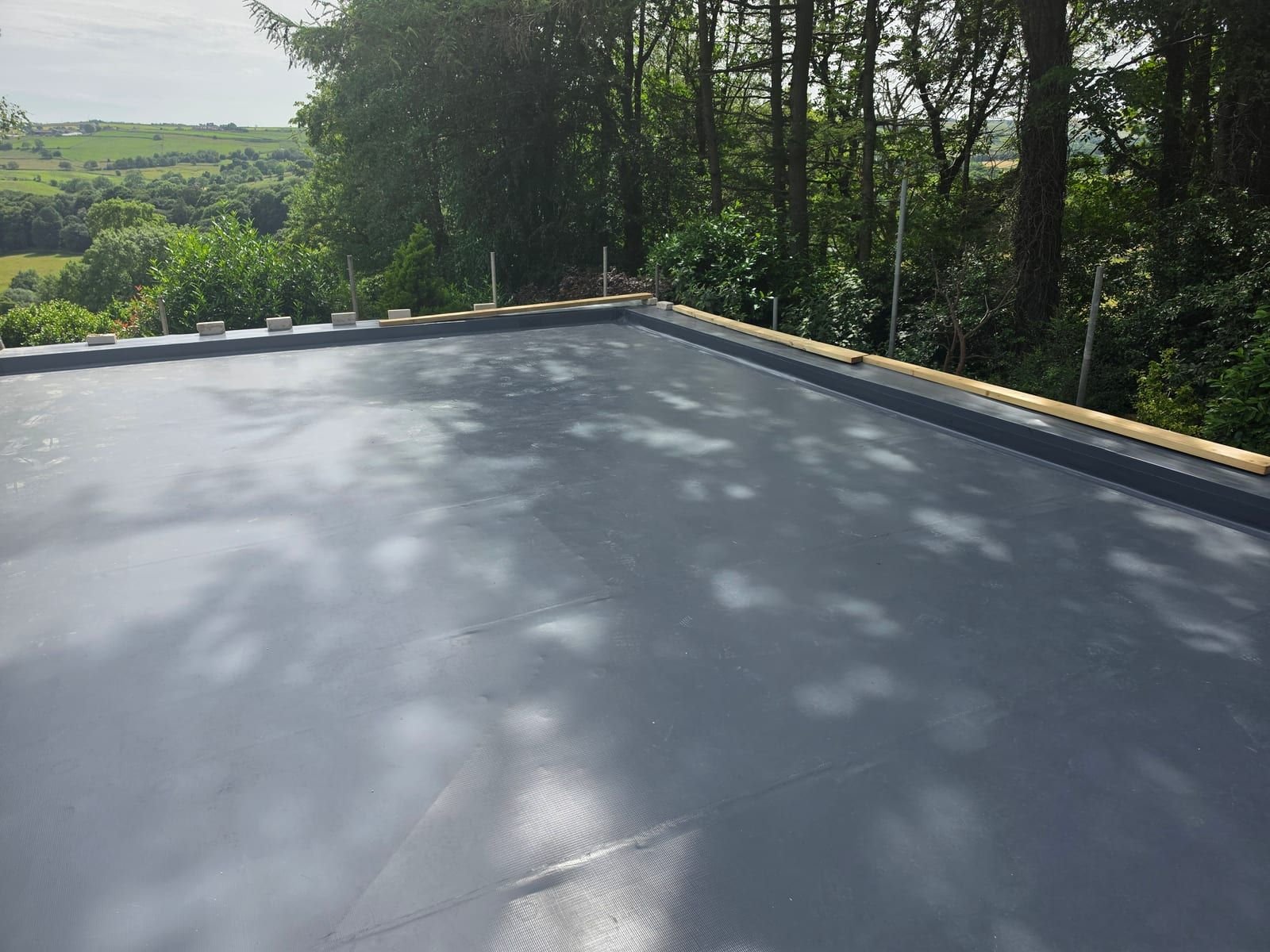Dark grey Fatra FF810 PVC single ply roof finished by Skyguard on a new garage in Sheffield, before the sedum trays went on