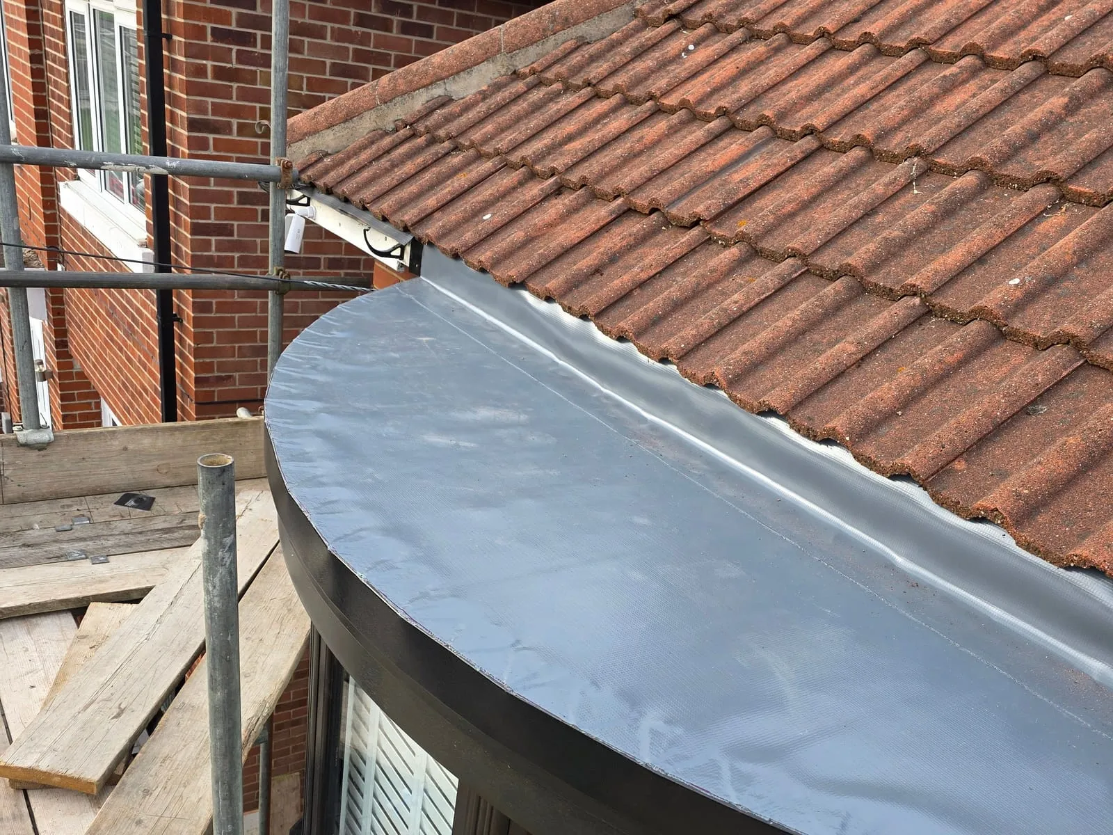 The same roof at 4.29 pm, finished in grey Fatra single ply and turned up under the bottom row of tiles